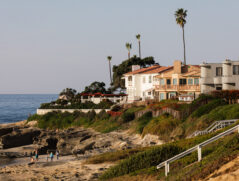Luxury San Diego million dollar homes situated on a coastal bluff overlooking the rocky beach and ocean in La Jolla.